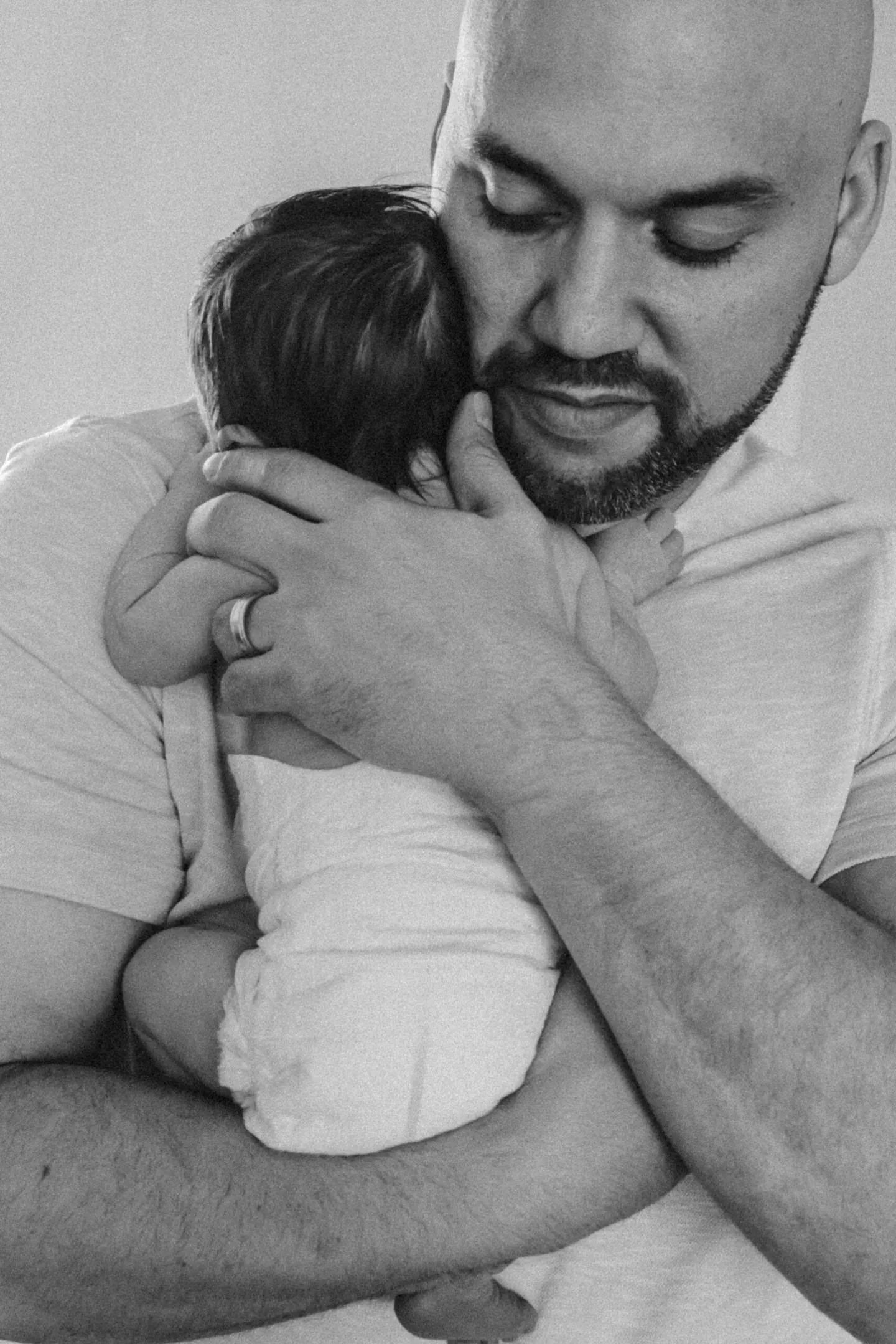 dad with newborn baby in home newborn photos in Charlottesville