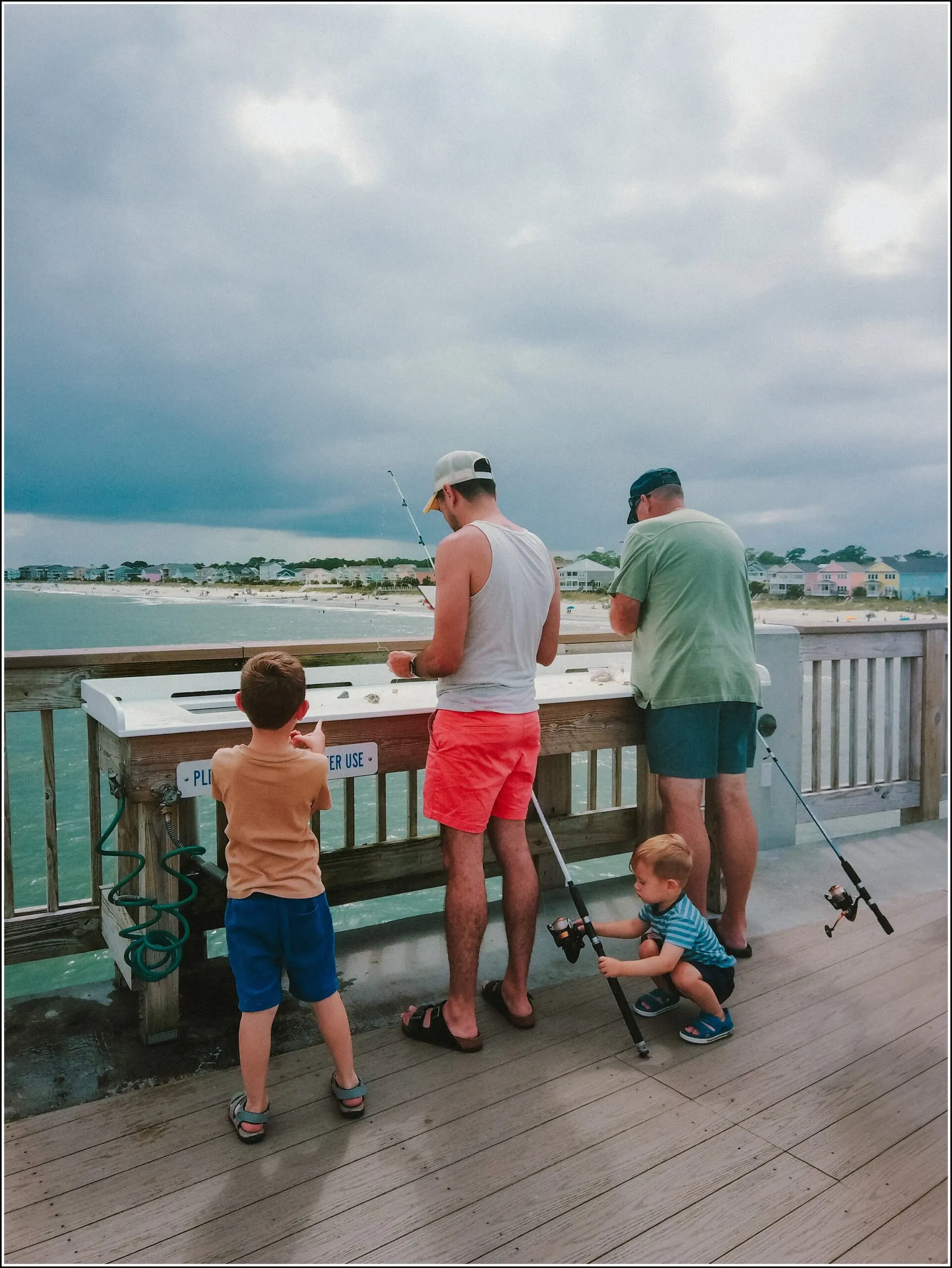 boys fishing from a pier, taken with a point and shoot camera