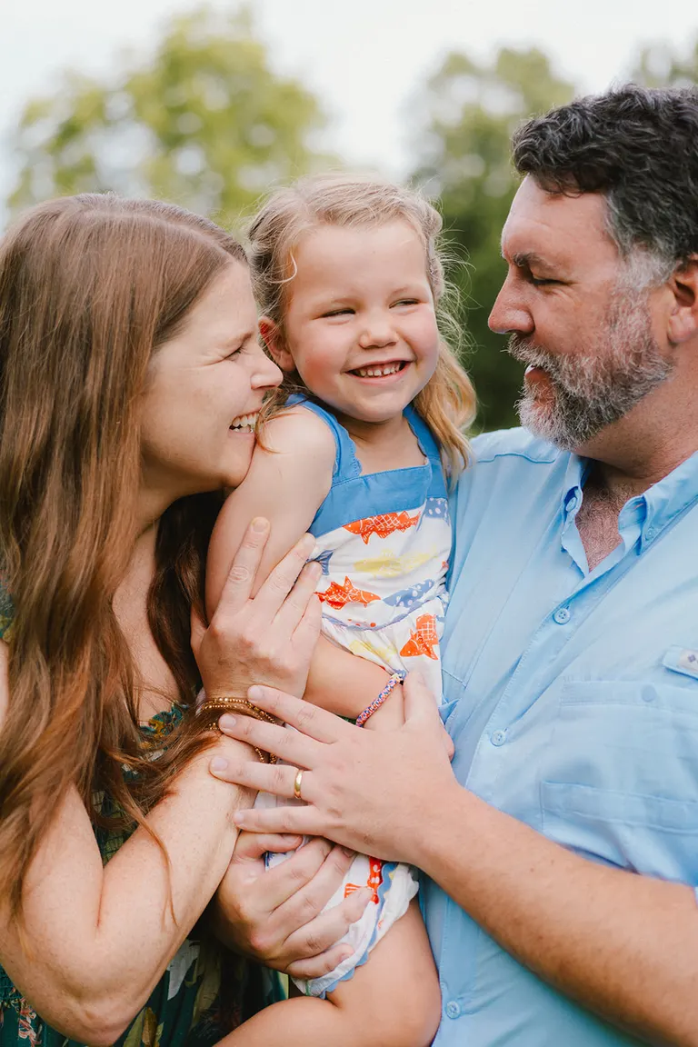 pose for a family of three in outdoor family photos