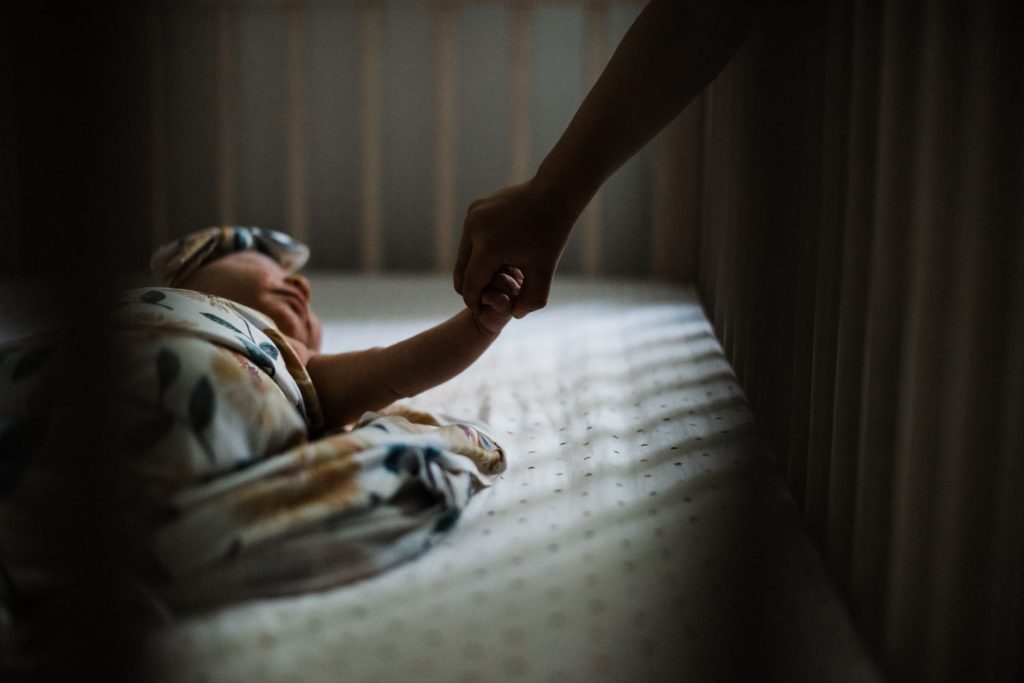 siblings holding hands in the crib, newborn photos charlottesville va