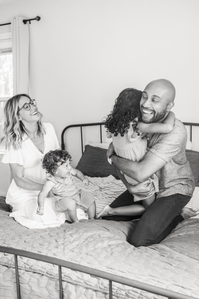 lifestyle family photo poses on master bed