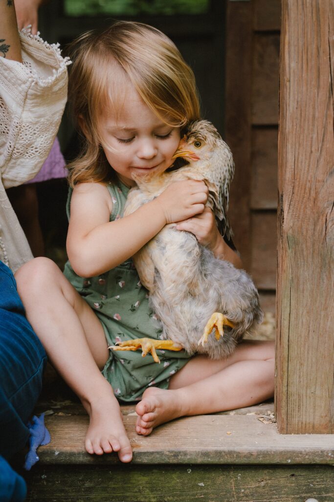 family photos at home with a chicken coop