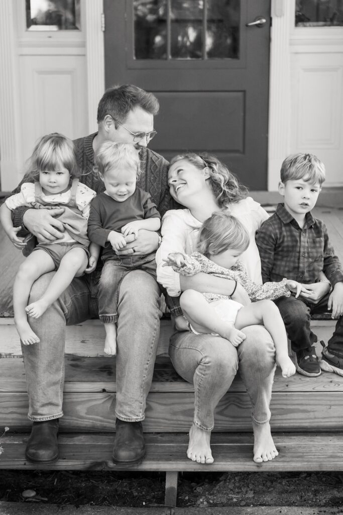 family pose for lifestyle photography session at home with four kids