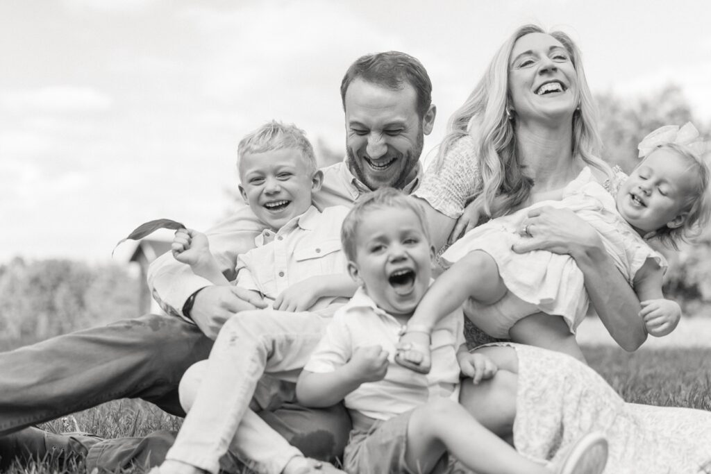 posing with three kids in an outdoor family session