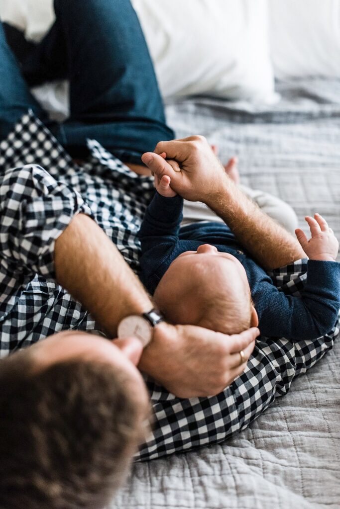 dad holding baby's hand, foundations for slow season as a family photographer 