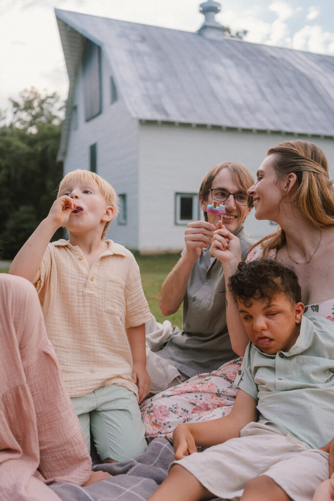family with special needs on a blanket eating popsicles during summer mini sessions in Virginia