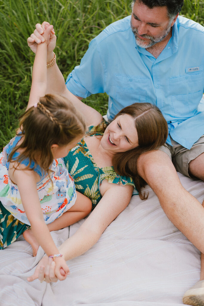 photos of a family of three in a field in the summer, charlottesville va