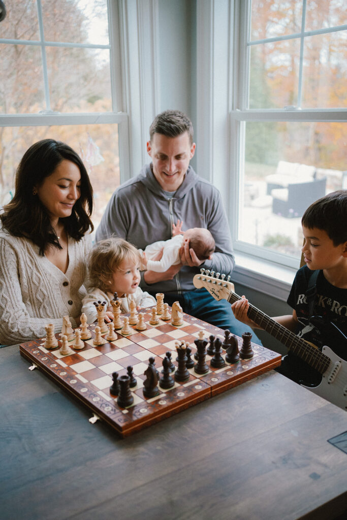 family with three brothers at the kitchen table in charlottesville newborn photos