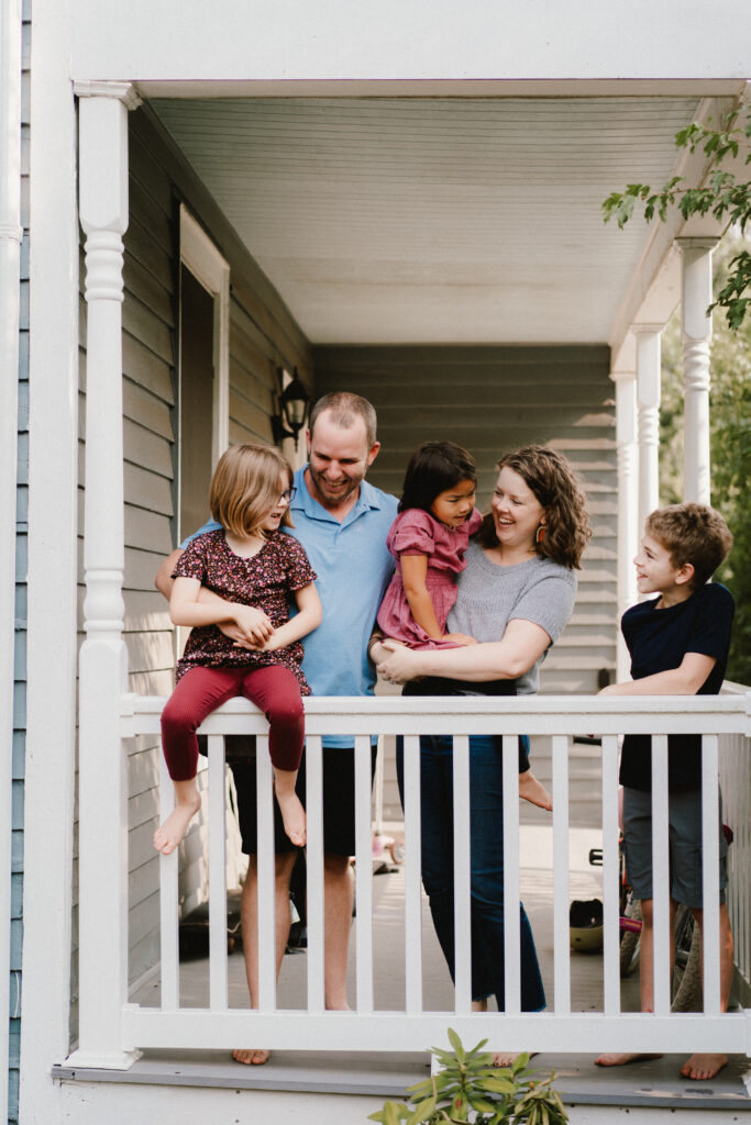 Relaxed in-home family photography Charlottesville VA - family on front porch during Home Sweet Home session